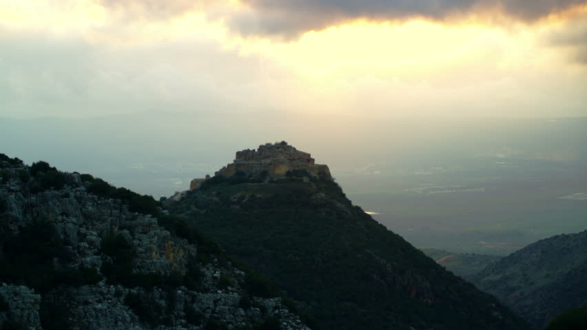 Static, somewhat silhouetted wide shot of Nimrod Fortress, Golan Heights, Israel