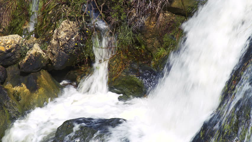 Close up of the water crashing down the rocks of the Tahana Waterfall near