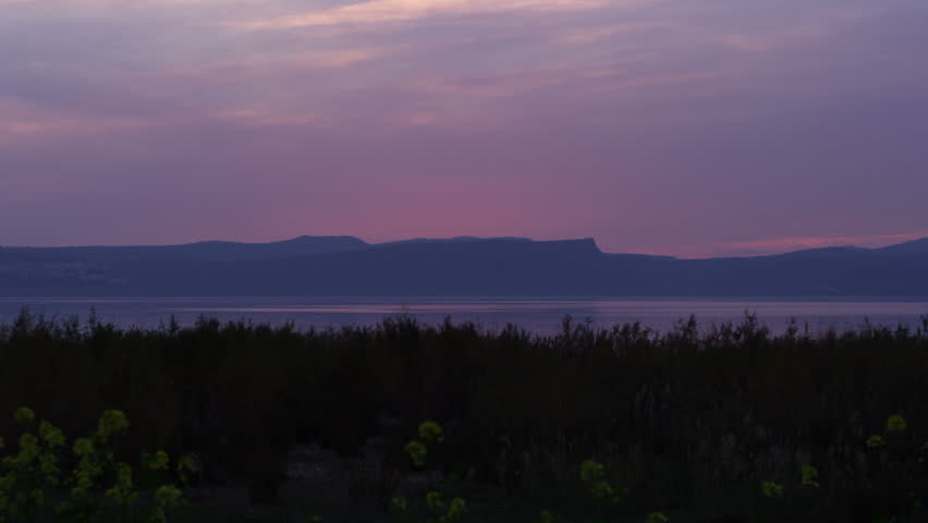 Panning shot of the red sunset at the Sea of Galilee in Israel  02/22/2011