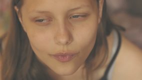 Portrait of a thoughtful attractive young girl, closeup. 4K UHD native video.