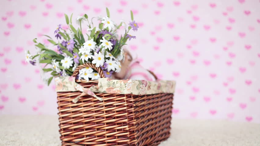 Girl with flowers sitting in a basket 