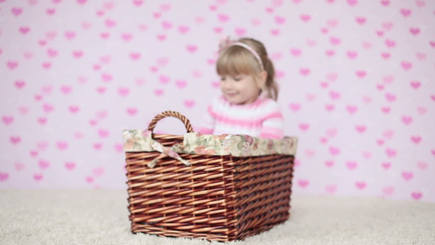 Happy child sitting in a basket 