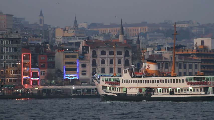 Ferry boat sails to Karakoy Port at night in Istanbul 