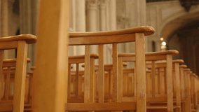 Church building Gothic interior with chairs in a row 4K 2160p 30fps UltraHD  tilting footage - Wooden cathedral seats in church building slow tilt 4K 3840X2160 UHD video
