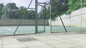 An establishing shot of an outdoor tennis court