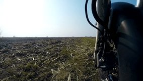 Unique low angle point of view of motorbike while riding on country road. High definition stock video footage clip.