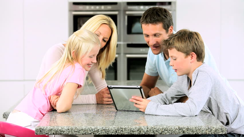 Young Caucasian Family Having Fun with  Wireless Tablet