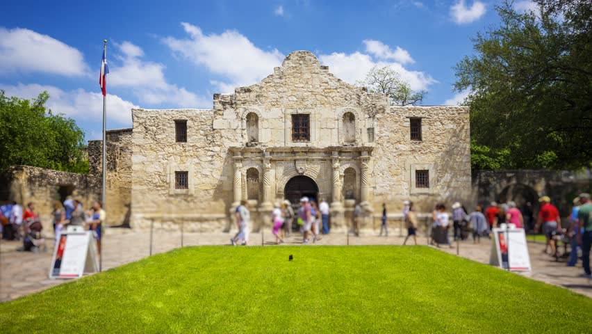 Exterior view of the historic Alamo in San Antonio, Texas with tourists, timelapse (People and signs blurred for commercial use)