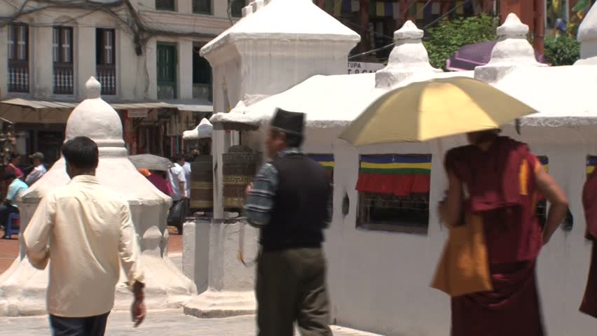 Monks walk by Boudha Strupa.