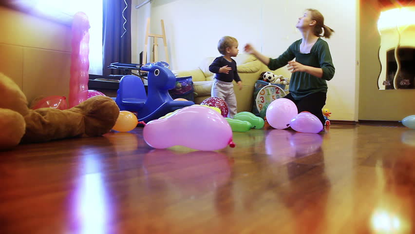 Mother and baby boy playing with balloons