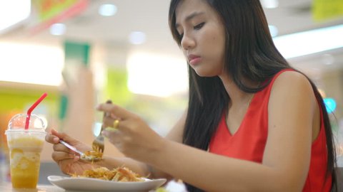Young Asian Lady eating Pad Thai in cafe 4k UHD (3840x2160)
