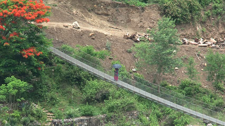 Walking across a bridge in Nepal.