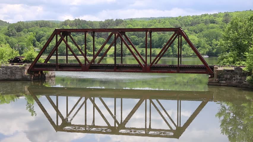 Amtrak train bridge crossing a body of water along the Connecticut River in Vermont.