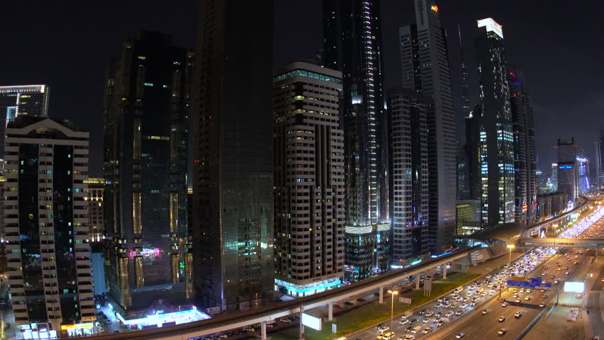 DUBAI, UNITED ARAB EMIRATES - FEBRUARY 2016: View down skyscrapers lining Sheikh Zayed Road at dusk, Dubai | Shutterstock HD Video #17170357