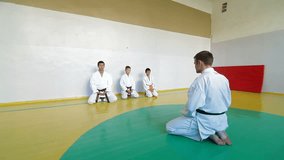 coach at the gym teaches children Martial Art