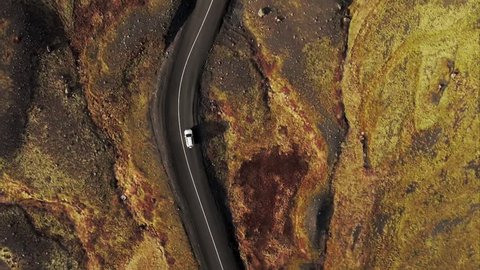 Directly above shot of car driving along a road through the open fields in Iceland

