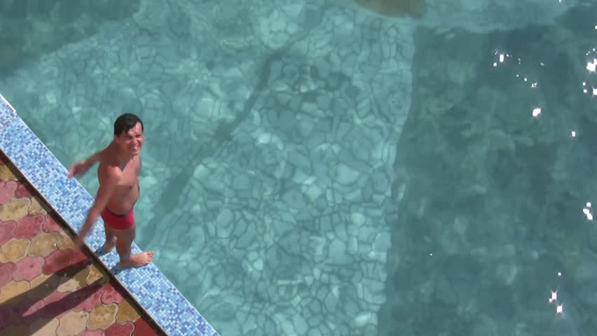 Man jumping in water pool 