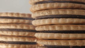 Fresh chocolate filled sandwich cookies close-up slow tilt 4K 2160p 30fps UltraHD footage - Sandwich biscuits with chocolate fill tasty dessert details 4K 3840X2160 UHD tilting video