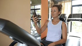 Smiling Fit Woman Talking on Phone by Video Call at Gym