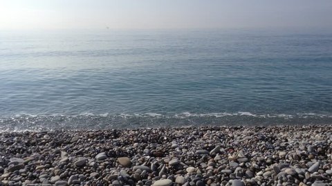 Mediterranean sea. Waves washing the pebble beach. The sound of the waves. 