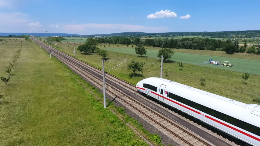 Wallau, Germany - June 07, 2016: Aerial tracking shot of passing german high speed train (ICE) on the Frankfurt-Cologne line near Wallau, Germany. The maximum speed of these trains is around 320km/h