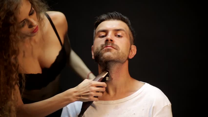 Sexy barber girl trimming a beard of a man Shutterstock HD Video #17188153 