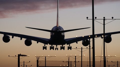 A Dramatic Shot of a 747 Landing at Sunset in Slow Motion.