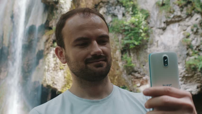 Young man taking selfies in nature