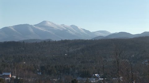 Pan across Adirondack Mountains with woods and houses below