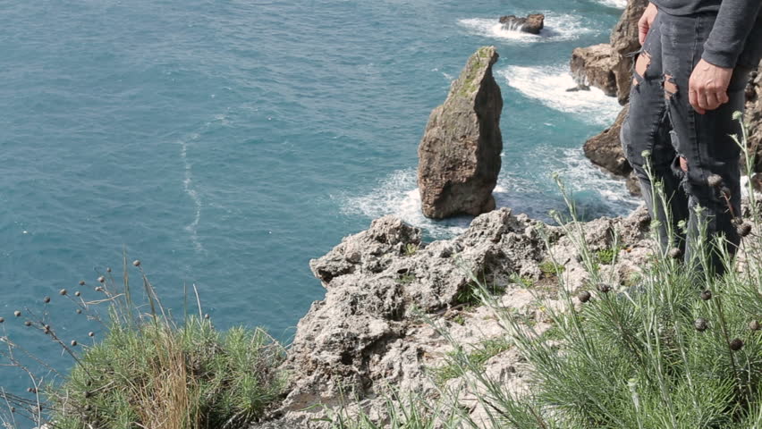  Women standing  on the  mouintain and  looking straight ahead. On the background on the Mediterranean seafront in sunny day.