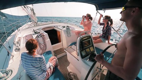 Friends sailing in the sea on the yacht. Color graded