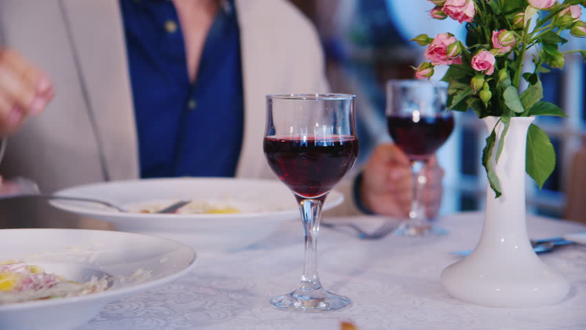 Man in suit eating in a restaurant. The only visible plate frame