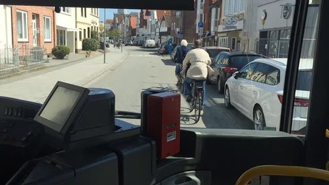 may 12, 2016 - Lubeck, Germany. Shooting from the bus, which travels on the road with two cyclists in the resort area of travemÃ¼nde
