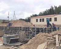 Workers concrete foundations for the house. Construction industry. 