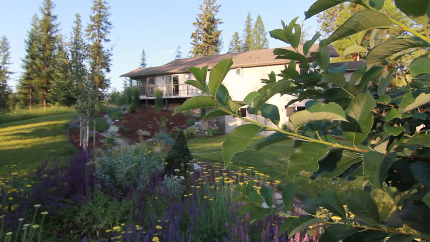 Exterior of back of house with garden in a forested area in Montana