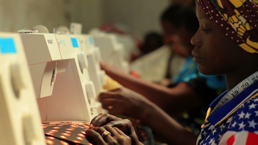 KENYA, AFRICA - CIRCA 2011:  A row of women sewing.