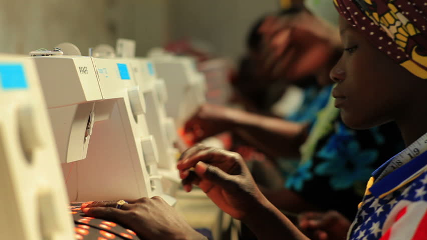 KENYA, AFRICA - CIRCA 2011:  A row of women sewing.