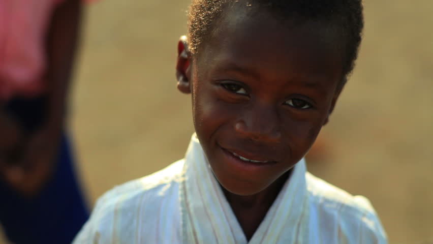 KENYA, AFRICA - CIRCA 2011: A boy looking at the camera and smiling.