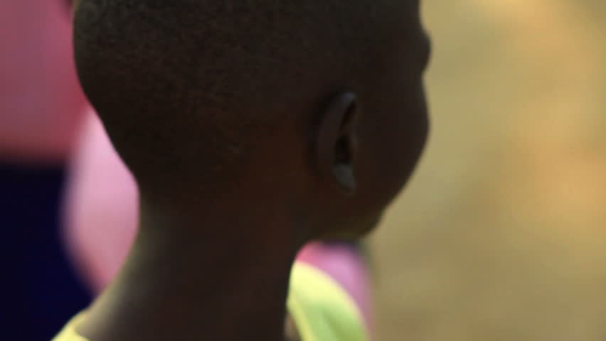 KENYA, AFRICA - CIRCA 2011: A little boy fixated on the camera.