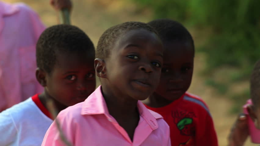 KENYA, AFRICA - CIRCA 2011: Small boys looking at the camera smiling.