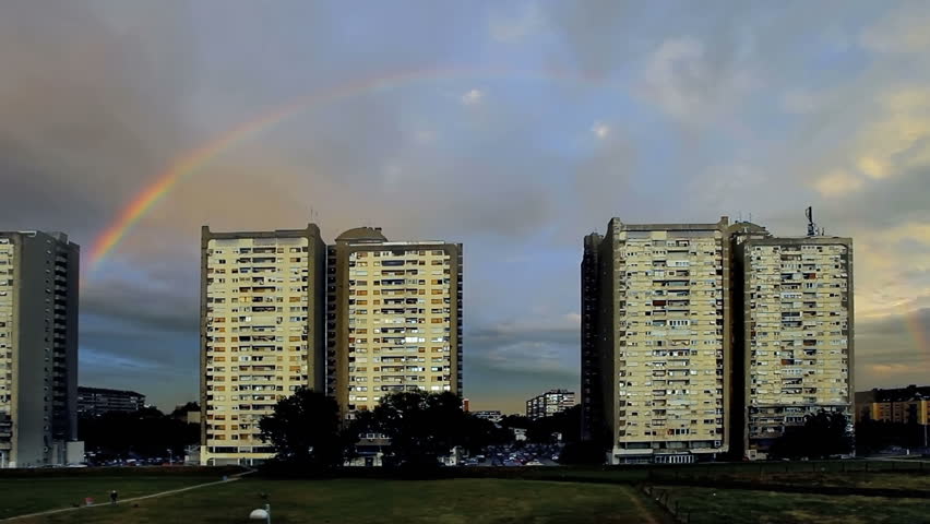 Rainbow In The City On Summer Day