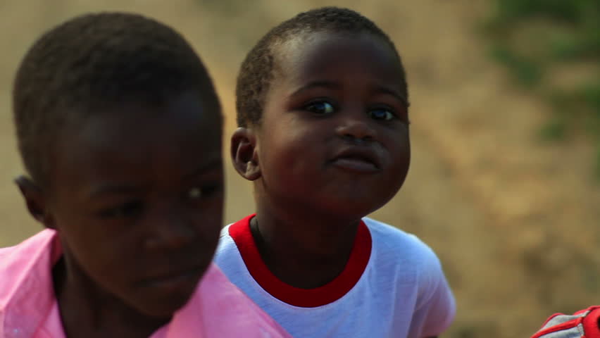 KENYA, AFRICA - CIRCA 2011: Little boy hiding behind another boy.
