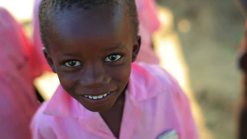 KENYA, AFRICA - CIRCA 2011: A boy smiling and looking at the camera.
