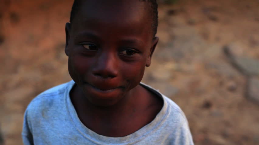KENYA, AFRICA - CIRCA 2011: A boy looking, laughing, and smiling at the camera.