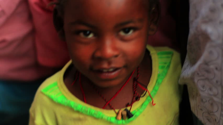 KENYA, AFRICA - CIRCA 2011: Little girl with a tote in her hand.