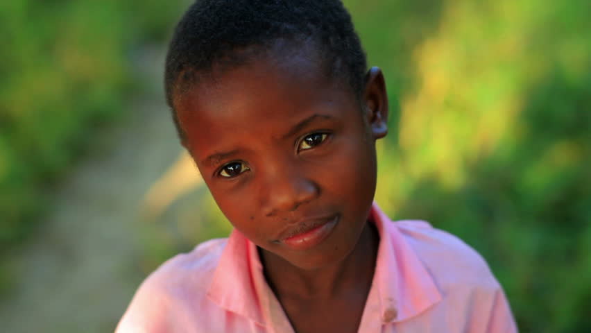 KENYA, AFRICA - CIRCA 2011: Little girl in a pink shirt smiling at the camera.