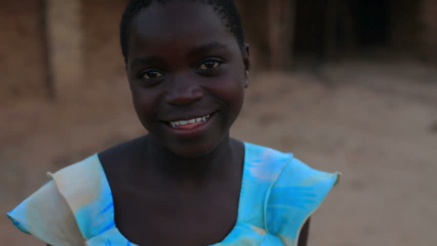 KENYA, AFRICA - CIRCA 2011: Girl in a blue shirt looking and smiling at the