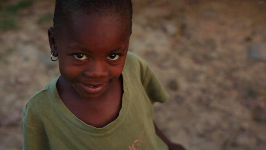 KENYA, AFRICA - CIRCA 2011: A little girl with earrings smiling.