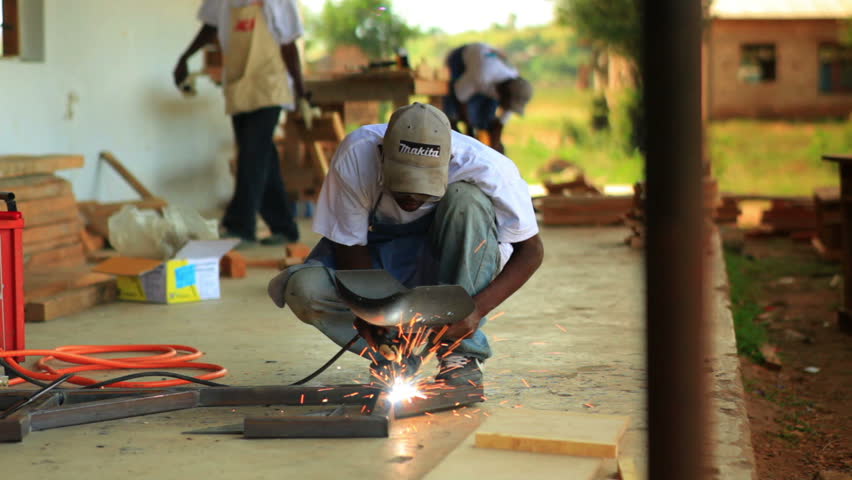 KENYA, AFRICA - CIRCA 2011: A metal worker does contruction in a village in