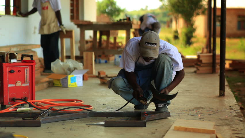 KENYA, AFRICA - CIRCA 2011: A metal worker does contruction in a village in